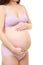 Pregnant woman wearing purple underwear touching her belly