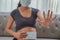 A pregnant woman wears a surgical mask to protect a COVID-19 Coronavirus and PM 2.5 and show stop sign shape by hand to prevent