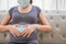 A pregnant woman wears a surgical mask to protect a COVID-19 Coronavirus and PM 2.5 and show a surgical mask on the abdomen to