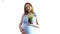 Pregnant woman on white background holds a pot of grass