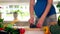 Pregnant woman wife sharpening knife with special tool at home kitchen