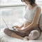 Pregnant woman working on computer at home