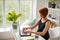 Pregnant woman working on laptop. Image of pregnant business woman typing something on laptop