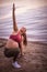 Pregnant woman working yoga on the beach