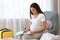 Pregnant woman writing packing list for maternity hospital