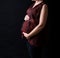 Pregnant women belly dressed in red blouse