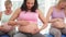 Pregnant women doing yoga in fitness studio