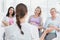 Pregnant women listening to gesturing doctor at antenatal class