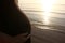 Pregnant women with sea and sunset landscape view