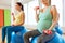 Pregnant women training with exercise balls in gym