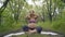 Pregnant yoga in the lotus position. in the park on the grass on the mat, doing exercises, breathing, stretching