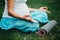 Pregnant yoga woman in the lotus position with mat portrait in park on the grass, breathing, stretching, statics.