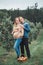 Pregnant young Caucasian woman with husband on apple farm