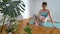 Pregnant young happy woman doing yoga by online workout. Pregnant woman in a twisting yogic pose. Yoga for pregnant women online.