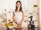 Pregnant Young Woman Cooking with Food Processor.