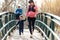 Pregnant young woman with her little son enjoying the time together outdoor while her husband take a photographs