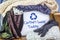 Preloved clothes in a box marked with board sign clothes swap today and recycle textiles symbol