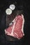 Premium Dry Aged Raw T-bone Steak on Rustic Kitchen Chopping Board