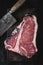 Premium Dry Aged Raw T-bone Steak on Rustic Kitchen Chopping Board