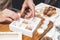 Premium handmade chocolate truffles. Woman confectioner packs chocolates in boxes. Close-up of female hands and tasty candies.