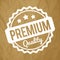 Premium Quality rubber stamp white on a crumpled paper brown background