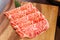 Premium Rare Slices Wagyu A5 beef with high-marbled texture on square wooden plate served for Sukiyaki and Shabu