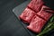 Premium raw Black Angus beef minute steak on Black wooden background. Slice wagyu