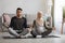 Prenatal Yoga Concept. Pregnant religious muslim couple meditating together at home