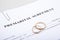 Prenuptial Agreement form and two wedding rings