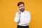 Preoccupied tired young bearded male chef cook or baker man in white uniform shirt posing isolated on yellow background