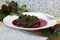 Prepaired braised amaranth - red spinach, in it`s own juce on white plate