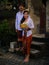 Preparation for Balinese ceremony. Multicultural couple preparing for Hindu religious ceremony with god`s offerings. Caucasian