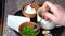 Preparation of borscht. Add sour cream and herbs to a plate with borscht.