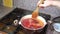 Preparation of borscht. Adding raw potatoes into the pan.