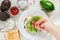 Preparation of bread toast with avocado, cottage cheese ricotta, coarse sea salt and pink pepper