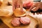 Preparation of burger.Cooking hamburger concept. Cook preparing burger adding meet. Cook cuts burger bun