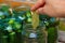 Preparation for canning cucumbers for the winter, woman arranges ingredients in a jar close-up