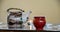 Preparation of chinese tea - table set with a kettle, cups, candles, and some green and black tea waiting to be done