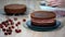 Preparation of chocolate cake with cherries. The cake is soaked with sweet syrup for moisture.