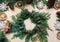 Preparation for Christmas holiday. Christmas composition of wreath, decor, dry orange, twigs and snowflakes.