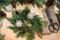 Preparation for Christmas holiday. Christmas composition of wreath, decor, dry orange, twigs and snowflakes. Woman prepare a wreat