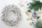 Preparation for Christmas time, advent wreath from white wood and decoration from fir branches, gingerbread cookies, ornaments and