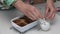 Preparation of cinnabons. A woman mixes icing sugar with sour cream. Glazes baked cinnabons. The camera moves on a slider. Close-