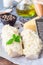 Preparation of cod fillet under cheese, mustard, pepper and cream crust, ingredients on background, vertical, closeup