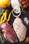 Preparation for cooking raw duck breast with ingredients close-up. vertical top view