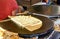 Preparation of crepes pancakes on a hot metal plate