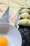 Preparation of croissants, stuffed with ham and cheese and painted with egg yolk, on a wooden board, ready to bake