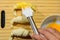 Preparation of croissants, stuffed with ham and cheese and painted with egg yolk, on a wooden board, ready to bake