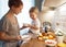 preparation of family breakfast. mother and baby son cook porridge in morning