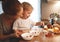 preparation of family breakfast. mother and baby son cook porridge in morning